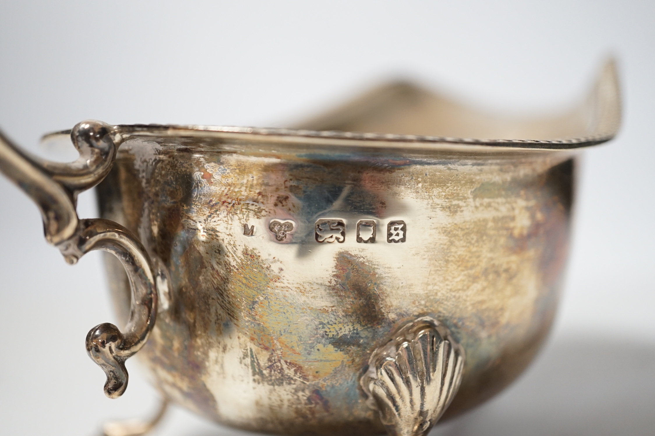 A 1930's silver sauceboat a silver mounted inkwell and one other item.